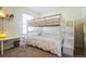 Bedroom with a bunk bed and a desk area with soft carpet at 13644 Ulster St, Thornton, CO 80602