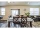 Cozy dining area with a wooden table, stylish decor, and access to outdoor space at 13644 Ulster St, Thornton, CO 80602