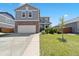 Well-maintained home featuring a two-car garage, brick accents, and a manicured front yard at 13644 Ulster St, Thornton, CO 80602