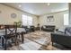 Open living room featuring modern decor, plush seating, and ample natural light at 13644 Ulster St, Thornton, CO 80602