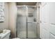 Bathroom shower with glass door and sleek hardware that complements the space's modern design at 13644 Ulster St, Thornton, CO 80602