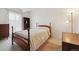 A cozy bedroom featuring a wooden frame bed and neutral decor exudes simplistic elegance at 8060 E Girard Ave # 712, Denver, CO 80231