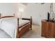 A cozy bedroom featuring a wooden frame bed and neutral decor exudes simplistic elegance at 8060 E Girard Ave # 712, Denver, CO 80231
