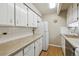 Efficient kitchen with ample white cabinetry and wood floor at 8060 E Girard Ave # 712, Denver, CO 80231