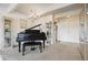 Inviting living room featuring a piano, chandelier, and neutral carpet at 8060 E Girard Ave # 712, Denver, CO 80231