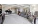 Inviting living room featuring a piano, chandelier, and neutral carpet at 8060 E Girard Ave # 712, Denver, CO 80231