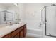 Bathroom with soaking tub, shower and wood vanity at 13456 Via Varra # 118, Broomfield, CO 80020