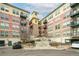 Modern apartment building with stone and red brick exterior at 13456 Via Varra # 118, Broomfield, CO 80020