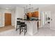 Modern kitchen with a breakfast bar and wood cabinets at 13456 Via Varra # 118, Broomfield, CO 80020