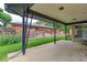 Spacious covered patio with a view of the green lawn and wooden fence at 353 S Niagara St, Denver, CO 80224