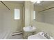 Bathroom with light green walls, pedestal sinks, and black and white tile floor at 353 S Niagara St, Denver, CO 80224