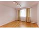 Bedroom with hardwood floors and window with curtains at 353 S Niagara St, Denver, CO 80224