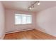 Bedroom with hardwood floors, window, and light pink walls at 353 S Niagara St, Denver, CO 80224