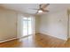 Bright bedroom features hardwood floors, a ceiling fan, and sliding glass doors to the backyard at 353 S Niagara St, Denver, CO 80224