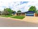 Well maintained brick home with blue trim, mature trees, and an attached two car garage at 353 S Niagara St, Denver, CO 80224