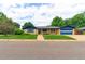 Charming brick home boasts a well-manicured lawn, blue trim, and an attached two car garage at 353 S Niagara St, Denver, CO 80224