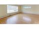 Bright living room features hardwood floors, large windows, and ample natural light at 353 S Niagara St, Denver, CO 80224