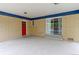 An outdoor patio with yellow brick, blue trim, and a red door at 353 S Niagara St, Denver, CO 80224