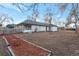 Spacious backyard with a large grassy area and a path leading to the back of the house at 1765 Ingalls St, Lakewood, CO 80214