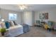 Bright and airy bedroom with carpeted floors, featuring a comfortable sitting area at 1765 Ingalls St, Lakewood, CO 80214