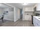 Modern white kitchen with stainless steel appliances and quartz countertops at 1765 Ingalls St, Lakewood, CO 80214