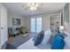 Spacious main bedroom with plush carpeting, a large bed and access to the outside at 1765 Ingalls St, Lakewood, CO 80214