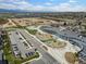 Aerial view showcasing local school, parking lot, and nearby fields at 1848 W 68Th Ave, Denver, CO 80221