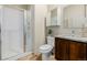 Bathroom featuring a tiled walk-in shower and modern vanity at 1848 W 68Th Ave, Denver, CO 80221