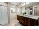 This bathroom features a granite double sink, stylish fixtures, and natural light at 1848 W 68Th Ave, Denver, CO 80221
