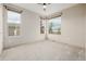 Bright carpeted bedroom with multiple windows and neutral colored walls at 1848 W 68Th Ave, Denver, CO 80221