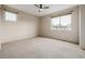 Bright carpeted bedroom with neutral walls and natural light from a large window at 1848 W 68Th Ave, Denver, CO 80221