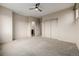 Neutral carpeted bedroom with closet, attached bath, ceiling fan and bright lighting at 1848 W 68Th Ave, Denver, CO 80221