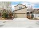 Two-story home with attached two-car garage and sidewalk at 1848 W 68Th Ave, Denver, CO 80221
