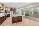 Open kitchen with stainless steel appliances and a large island with counter seating at 1848 W 68Th Ave, Denver, CO 80221
