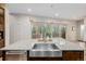 Close up of kitchen island with stainless steel sink and granite countertop at 1848 W 68Th Ave, Denver, CO 80221