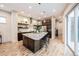 Modern kitchen features a large island with seating, stainless steel appliances, and light wood flooring at 1848 W 68Th Ave, Denver, CO 80221