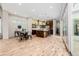 Open concept living room featuring wood floors, a dining area and a well appointed kitchen at 1848 W 68Th Ave, Denver, CO 80221