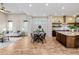 Spacious living room flows into a well-equipped kitchen with an island and bar stools at 1848 W 68Th Ave, Denver, CO 80221