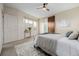 Well-lit bedroom features neutral paint, plush carpet, and a sliding barn door to the main bathroom at 1848 W 68Th Ave, Denver, CO 80221