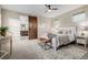 Beautiful main bedroom features a modern ceiling fan, sliding barn door to bath and natural light at 1848 W 68Th Ave, Denver, CO 80221