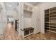 Mud room area featuring a bench, coat hooks, and storage cabinets at 1848 W 68Th Ave, Denver, CO 80221