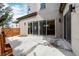 Spacious outdoor patio featuring sliding glass doors and wooden fence at 1848 W 68Th Ave, Denver, CO 80221