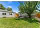Large backyard with detached garage and mature tree at 1111 E Dartmouth Ave, Englewood, CO 80113