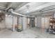 Unfinished basement with concrete floor, exposed beams, and visible utilities, ready for customization and storage at 1111 E Dartmouth Ave, Englewood, CO 80113
