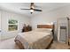 Cozy bedroom featuring a wooden bed frame and ceiling fan at 1111 E Dartmouth Ave, Englewood, CO 80113