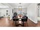 Dining room features a long wooden table and hardwood floors at 1111 E Dartmouth Ave, Englewood, CO 80113