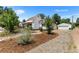 House exterior with gravel driveway and landscaping at 1111 E Dartmouth Ave, Englewood, CO 80113