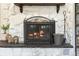Fireplace with white stone surround and black metal screen at 1111 E Dartmouth Ave, Englewood, CO 80113
