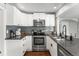 Modern kitchen with stainless steel appliances and gray countertops at 1111 E Dartmouth Ave, Englewood, CO 80113