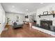Bright living room features a cozy fireplace and hardwood floors at 1111 E Dartmouth Ave, Englewood, CO 80113